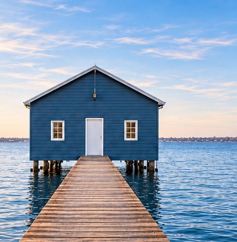 The blue Crawley boatshed and its timber jetty on Perth's Swan River